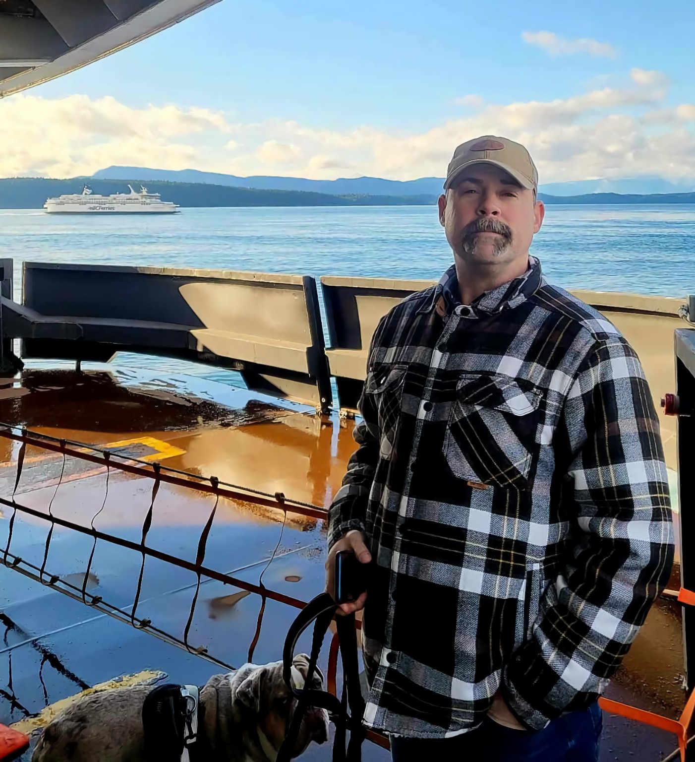 Brian Robert Lefebvre with his dog on the outer deck of a BC ferry in 2025