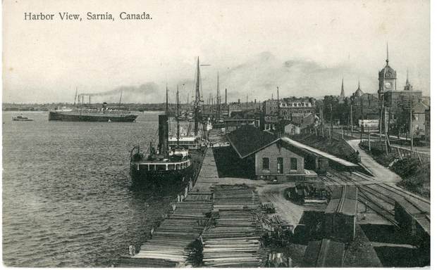 A harbour view with a steamer at a wooden wharf.