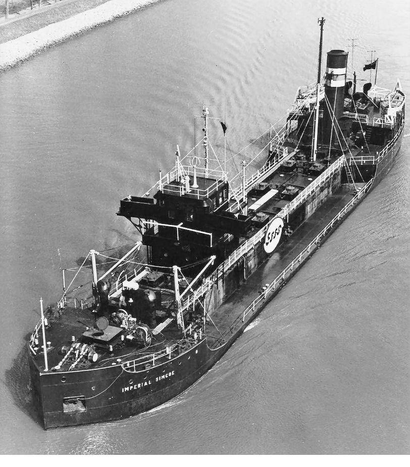 Looking down onto a tanker's deck from above: pipework, hatches, catwalk and winches.