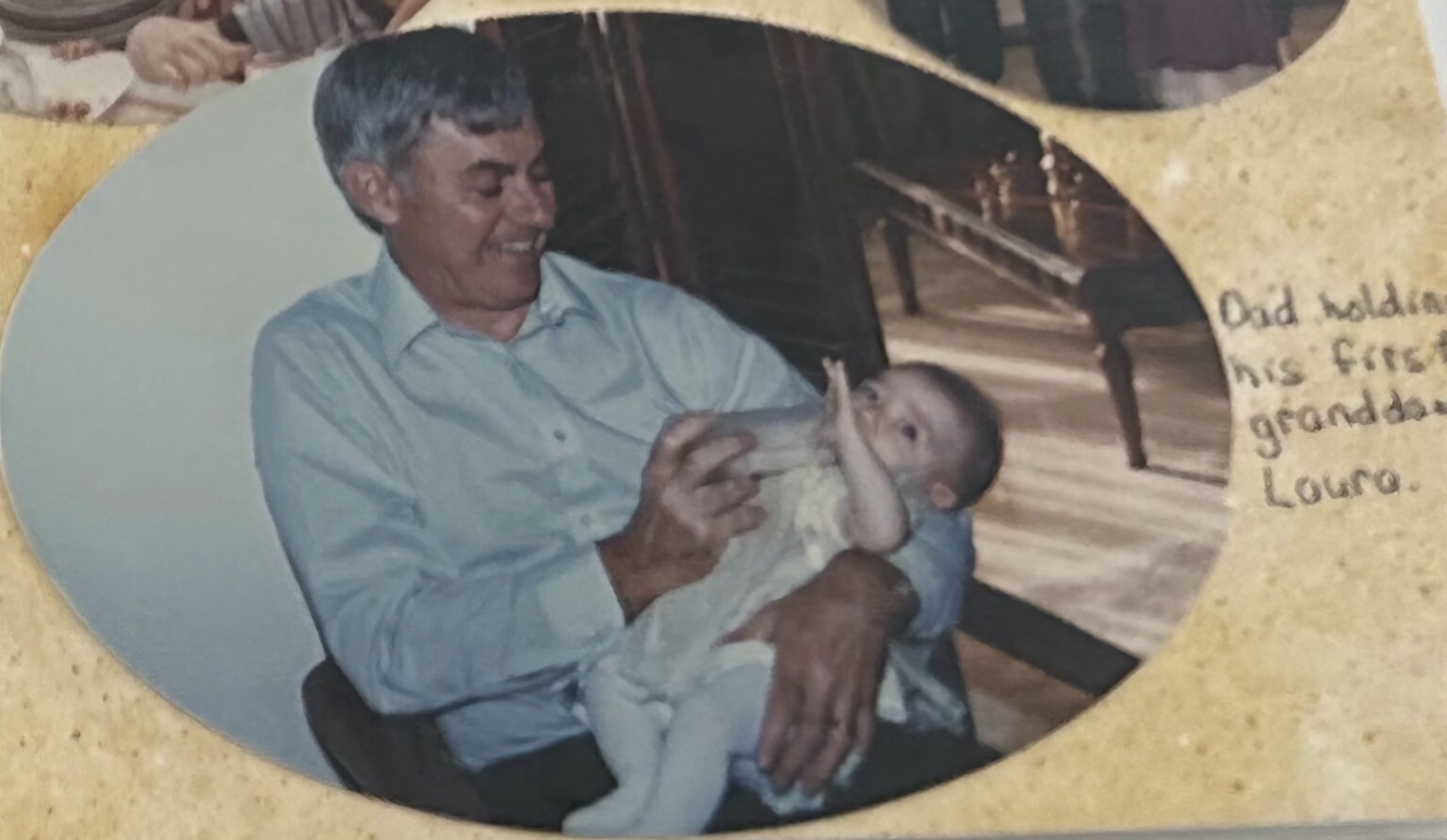 Robert Davies holding infant granddaughter Laura Cannon at Allandale