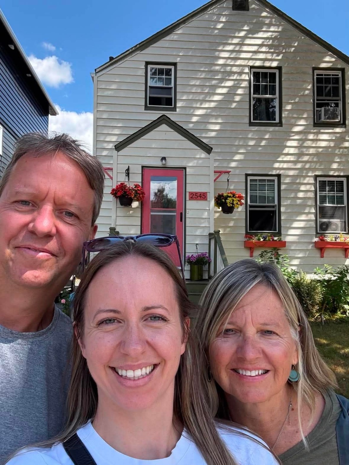 Dave McCoy, Melissa McCoy and Sandra McCoy in front of 2545 Beech Street in Halifax