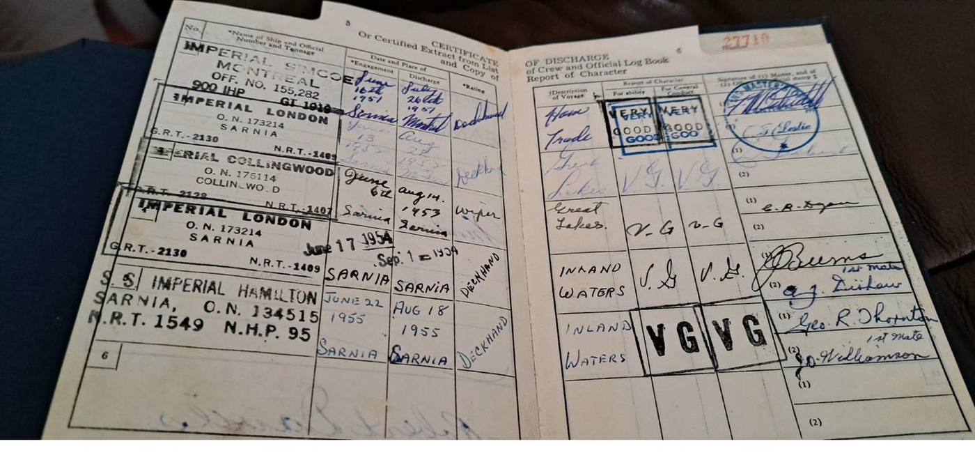 An old open booklet with ruled columns, ship names stamped in ink, and handwriting in fountain pen.