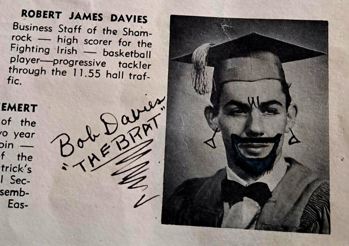 A yearbook page: a graduation photo defaced in ink with a beard and moustache, beside a large ink signature reading Bob Davies, The Brat.