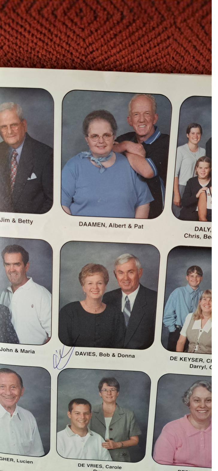A page of a church directory showing rows of family portraits with printed surnames beneath.