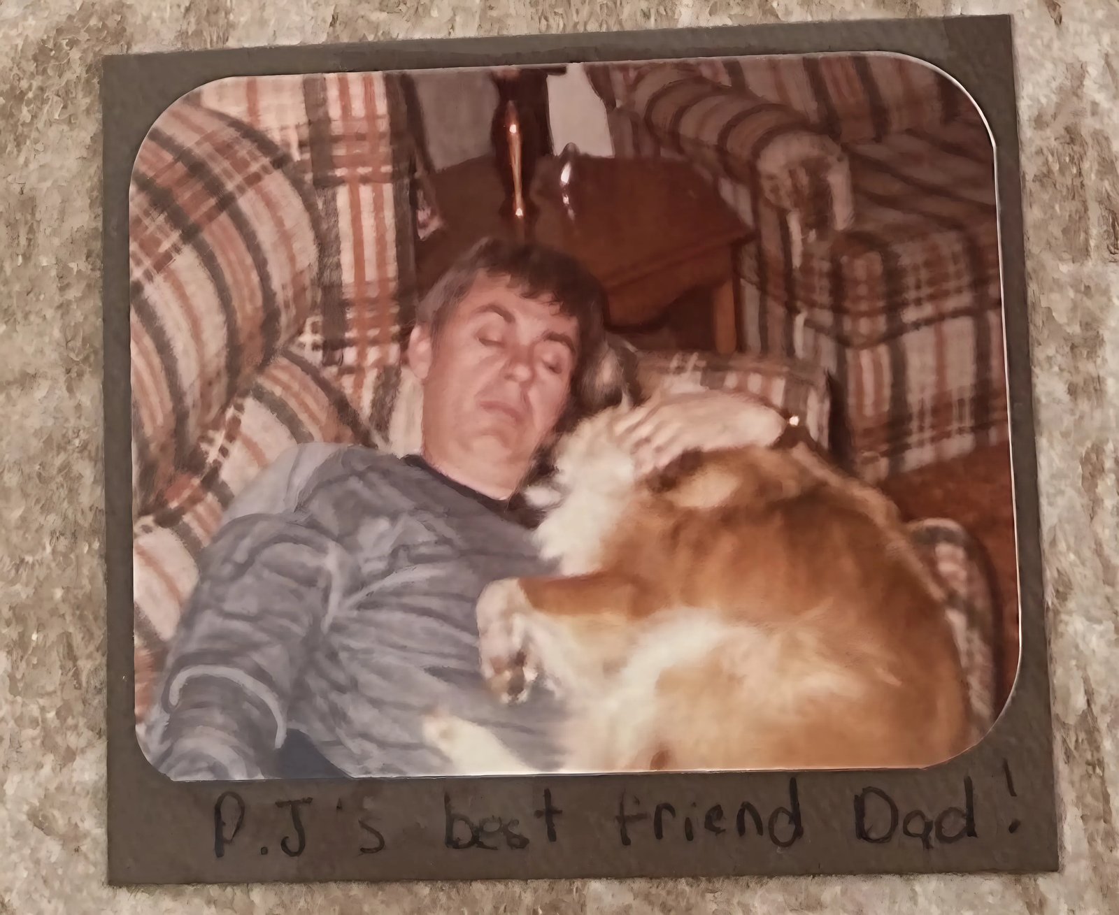 Robert Davies asleep beneath the family dog PJ