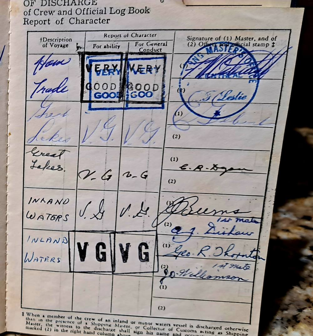 A page headed Certificate of Discharge for Seamen with a handwritten place of birth and a signature.