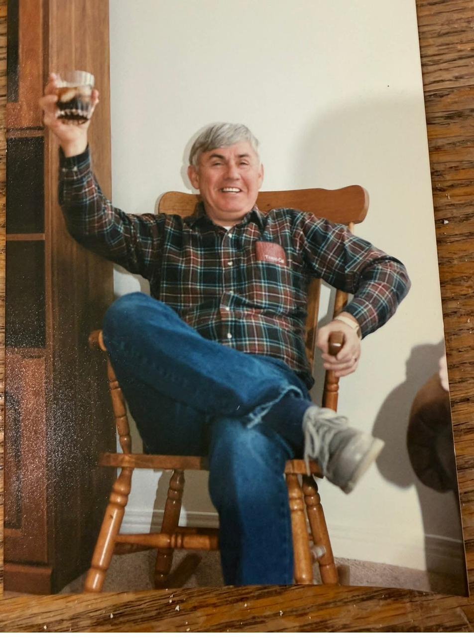 Robert Davies in his rocking chair with a glass raised