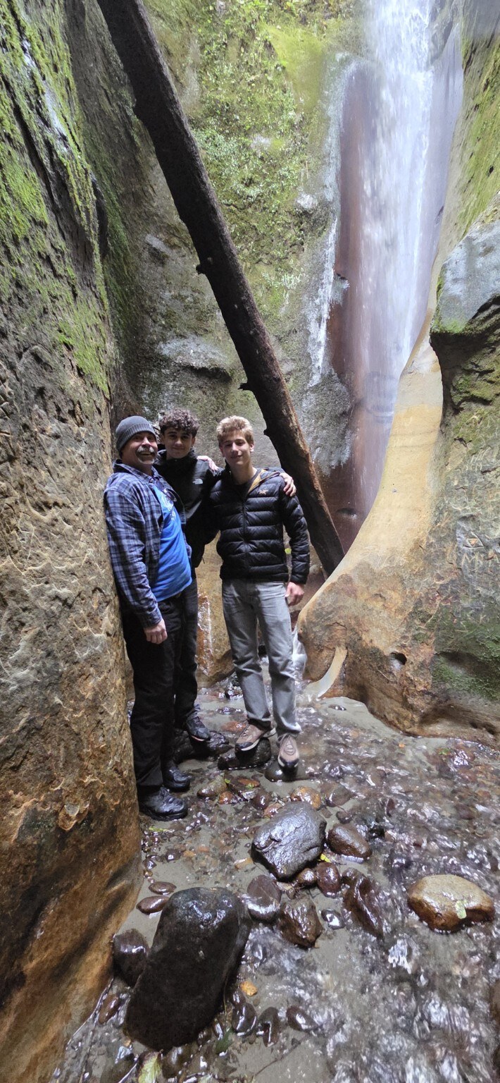 Brian Lefebvre, Jonte and Jonte’s friend beneath the waterfall at Sombrio Beach in 2025