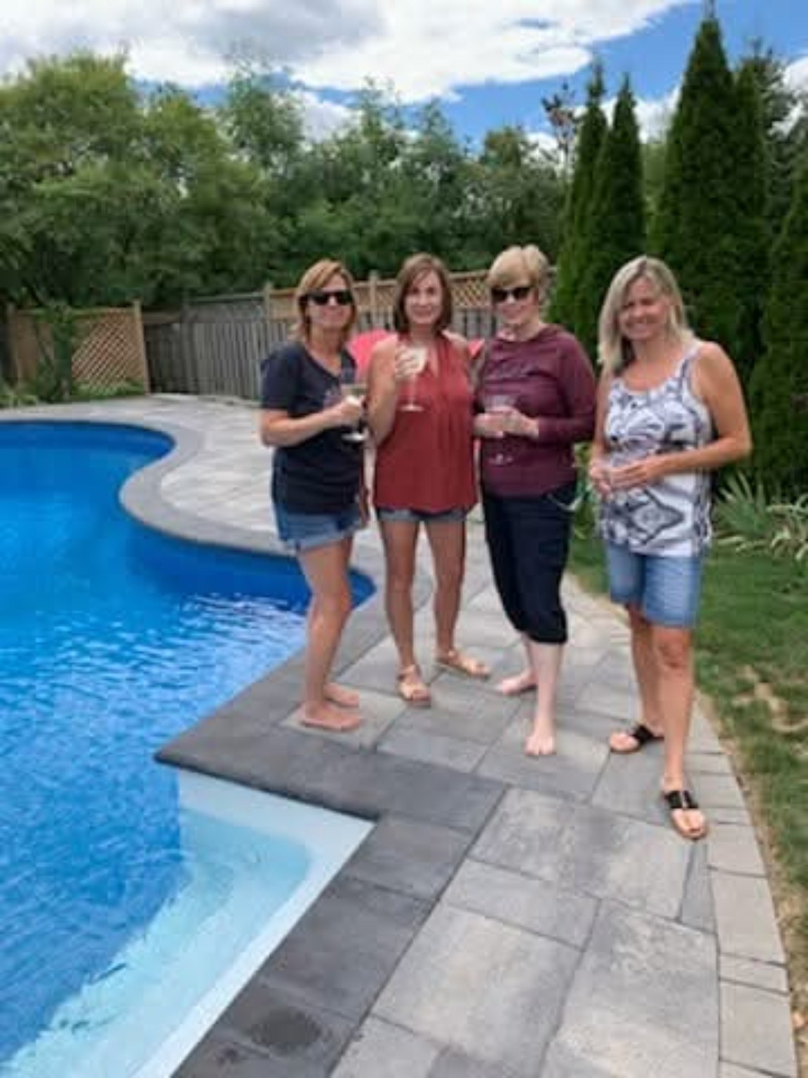 Brenda and her three sisters standing beside Sandra’s pool at the start of their 2019 Great Lakes trip